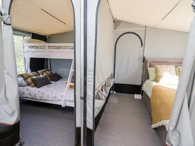 a room with two bunk beds in a trailer at The Otter in Rhayader