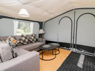 a living room with a couch and a table at The Otter in Rhayader