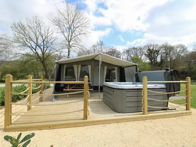 a tent with a hot tub on a wooden deck at The Kingfisher in Rhayader