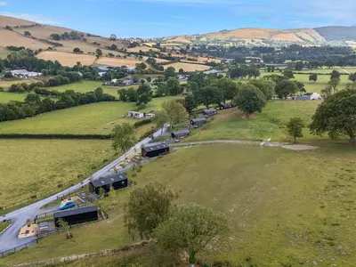 an aerial view of a farm with cars on a road at The Kingfisher in Rhayader