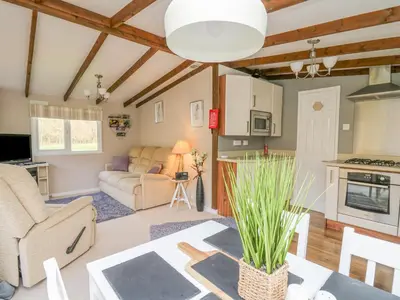a living room with a couch and a table at Riverside Rest in Builth Wells