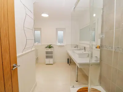 a bathroom with a sink and a shower at Machlud Haul in Llwyngwril