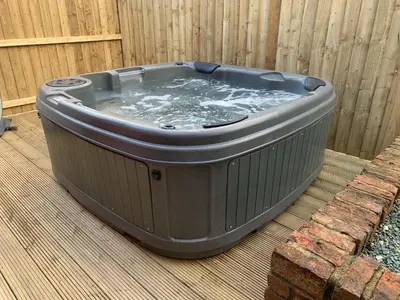a hot tub sitting on top of a deck at Owlbury Hall Barn in Montgomery