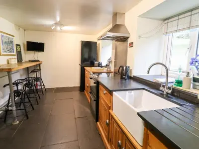 a kitchen with a sink and a stove at Gwengraig in Dolgellau