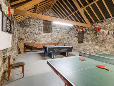 a ping pong table in a room with a ping pong ball at Gwengraig in Dolgellau
