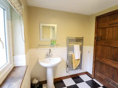 a bathroom with a sink and a mirror at Gwengraig in Dolgellau