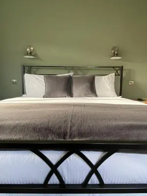 a bedroom with a large bed with two pillows at Marshpools Bed & Breakfast - Licensed near Weobley village in Weobley