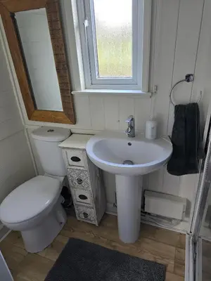 a small bathroom with a toilet and a sink at Glamping Hut - Sleeps 2 hot tub & parking in Welshpool