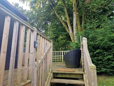 a wooden stairway with a black pot sitting on it at Glamping Hut - Sleeps 2 hot tub & parking in Welshpool