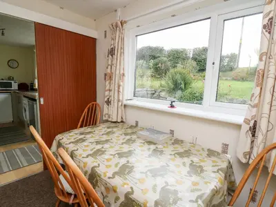 a dining room with a table and a window at Llwynon in Aberystwyth