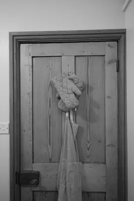 a wooden door with a towel hanging on it at Cwmbach Cottage, Hay on Wye in Glasbury