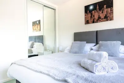 a bedroom with a large white bed with towels on it at Fair View - Off Street Parking and Garden in Shrewsbury