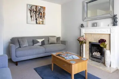 a living room with a couch and a fireplace at Fair View - Off Street Parking and Garden in Shrewsbury