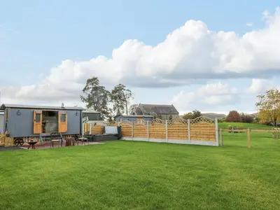 a luxurious caravan conversion with a fence and a yard at Poppy in Rhayader