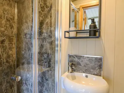 a bathroom with a sink and a shower at Poppy in Rhayader
