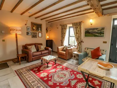 a living room with a couch and a table at Pen Bont Home Farm in Brecon