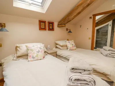 two twin beds in a room with a window at Pen Bont Home Farm in Brecon