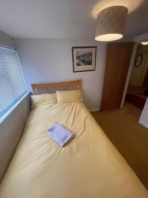 a bed with a towel on it in a bedroom at Chandeliers 6 in Shrewsbury