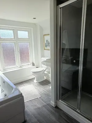 a bathroom with a shower and a toilet and a sink at Chandeliers 6 in Shrewsbury