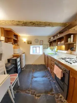 a kitchen with a floor that is covered in water at Longhouse - Y Beudy in Rhayader