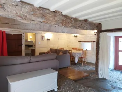 a living room with a couch and a table at Longhouse - Y Beudy in Rhayader