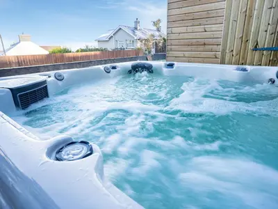 a jacuzzi hot tub with water in it at Dau Ddeg in New Quay