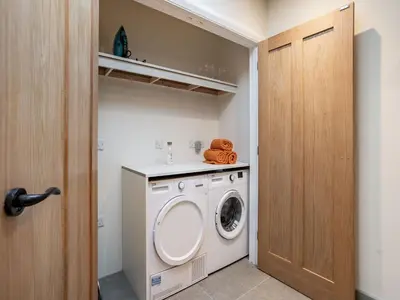 a laundry room with a washer and dryer at Dau Ddeg in New Quay