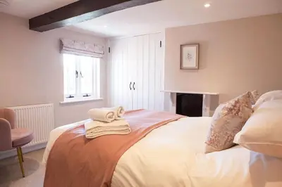 a bedroom with a bed with towels on it at Marrington Farmhouse in Chirbury