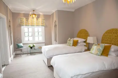 a bedroom with two beds and a window at Marrington Hall in Chirbury