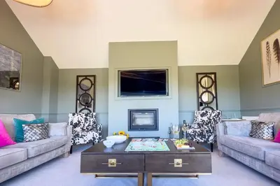 a living room with two couches and a coffee table at Roundton Farmhouse in Chirbury