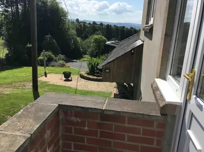 a brick wall with a view of a yard at Ravens Rest in Llanwrda