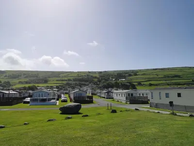 a small town with houses and a grass field at Snowdonia Sunbeach Holiday Sea and Mountain view in Llwyngwril