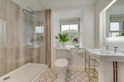 a bathroom with a toilet and a sink and a shower at 4 Bed in Brithdir oc-wag722 in Cross Foxes