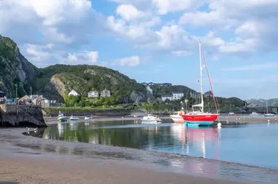 a sailboat is docked in the water on the beach at 4 Bed in Brithdir oc-wag722 in Cross Foxes