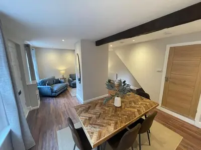 a dining room with a table and a couch at Georgian 3 bed house in historic town centre in Shrewsbury