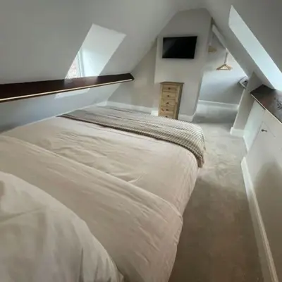 a bedroom with a large bed in a attic at Georgian 3 bed house in historic town centre in Shrewsbury
