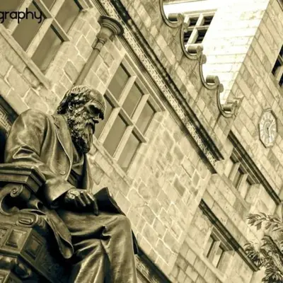 a statue of a man sitting in front of a building at Georgian 3 bed house in historic town centre in Shrewsbury