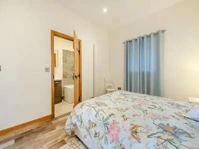a bedroom with a bed and a bathroom at Ty Gwair - Uk41512 in Lampeter
