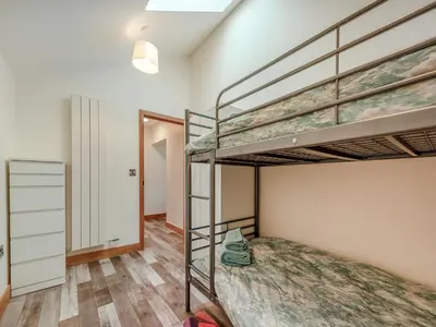 a bedroom with two bunk beds and a closet at Ty Gwair - Uk41512 in Lampeter