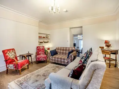 a living room with a couch and chairs at Brynog Mansion Apartment in Cilcennin