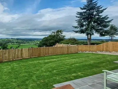a backyard with a fence and a tree at Yr Hen Beudy in Tregaron