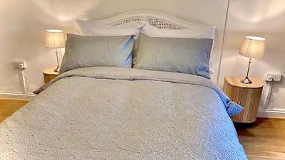 a bedroom with a large bed with two lamps at Dove Cottage in Newbridge on Wye