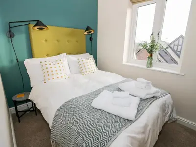 a bedroom with a bed with towels on it at The Stokesay in Ludlow