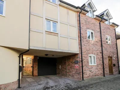 an external view of a brick building with a garage at The Stokesay in Ludlow