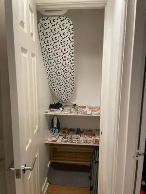 a walk in closet with a shelf and a mirror at Flat 2, Ty Newydd in Barmouth