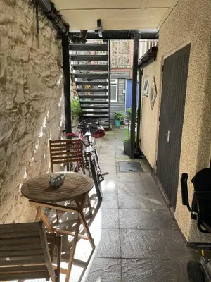 a table and a bike parked next to a building at Flat 2, Ty Newydd in Barmouth