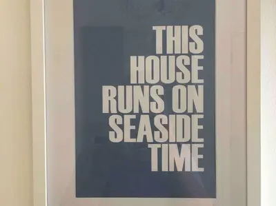 a sign that reads this house runs on secluded time at Tre Mynach Barmouth in Barmouth