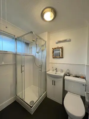 a bathroom with a shower and a toilet and a sink at Holiday home, Tywyn, great location in Tywyn