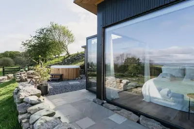 a glass house with a bedroom and a garden at Dyffryn Ceri in Penuwch
