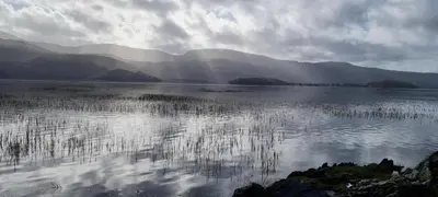 a large body of water with mountains in the background at Y Swdio, Ferm Glandwr in Barmouth